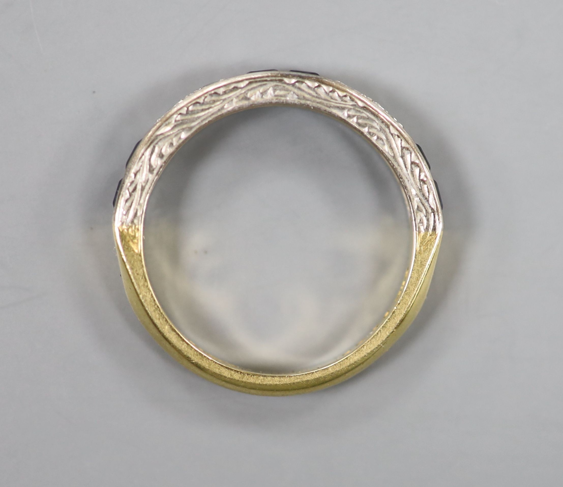 A modern 18ct gold and channel set six stone sapphire and four stone diamond half hoop ring, size O, gross 4.8 grams.